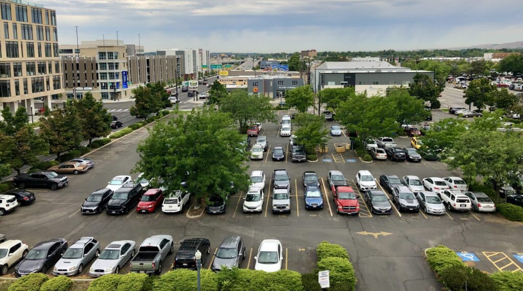 A surface parking lot filled with cars.