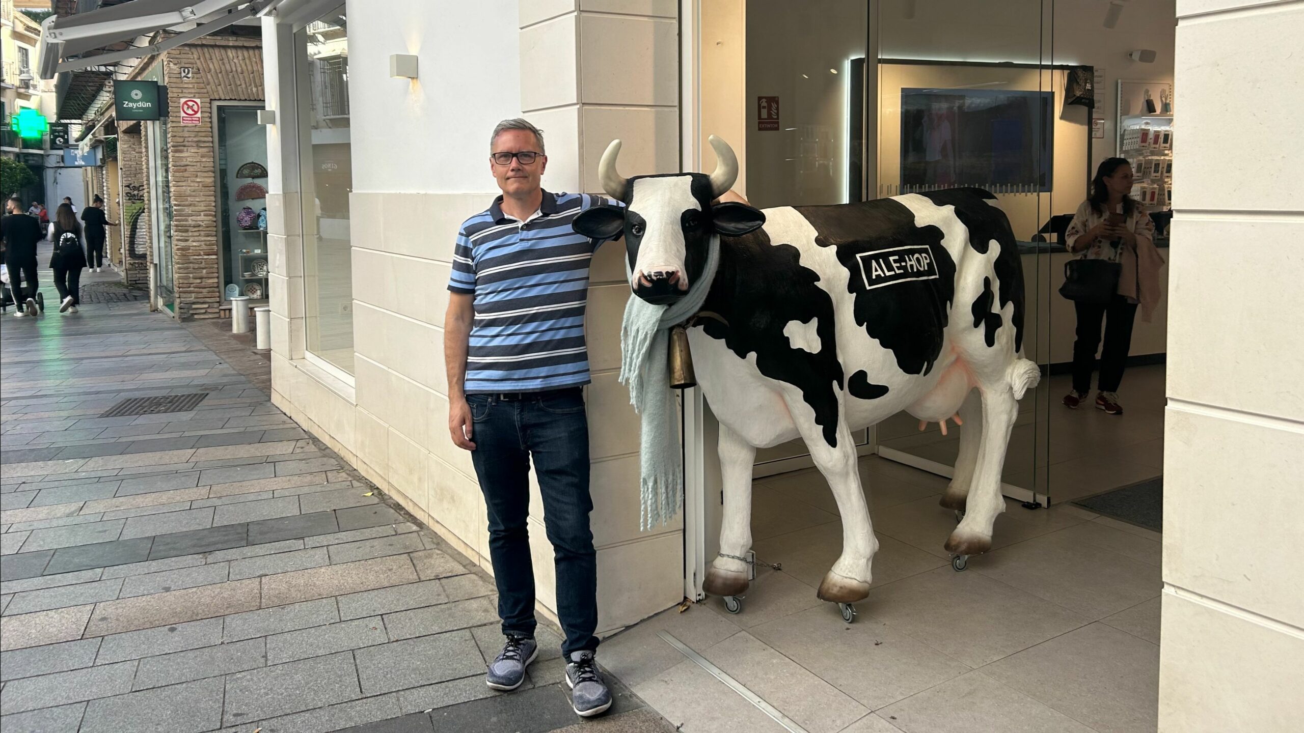 CityNerd standing outside beside a fake cow statue
